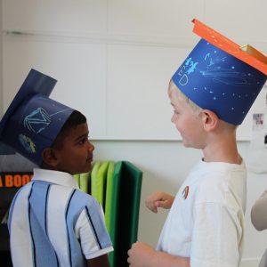 Kindergarten children graduating at ISB with homemade hats